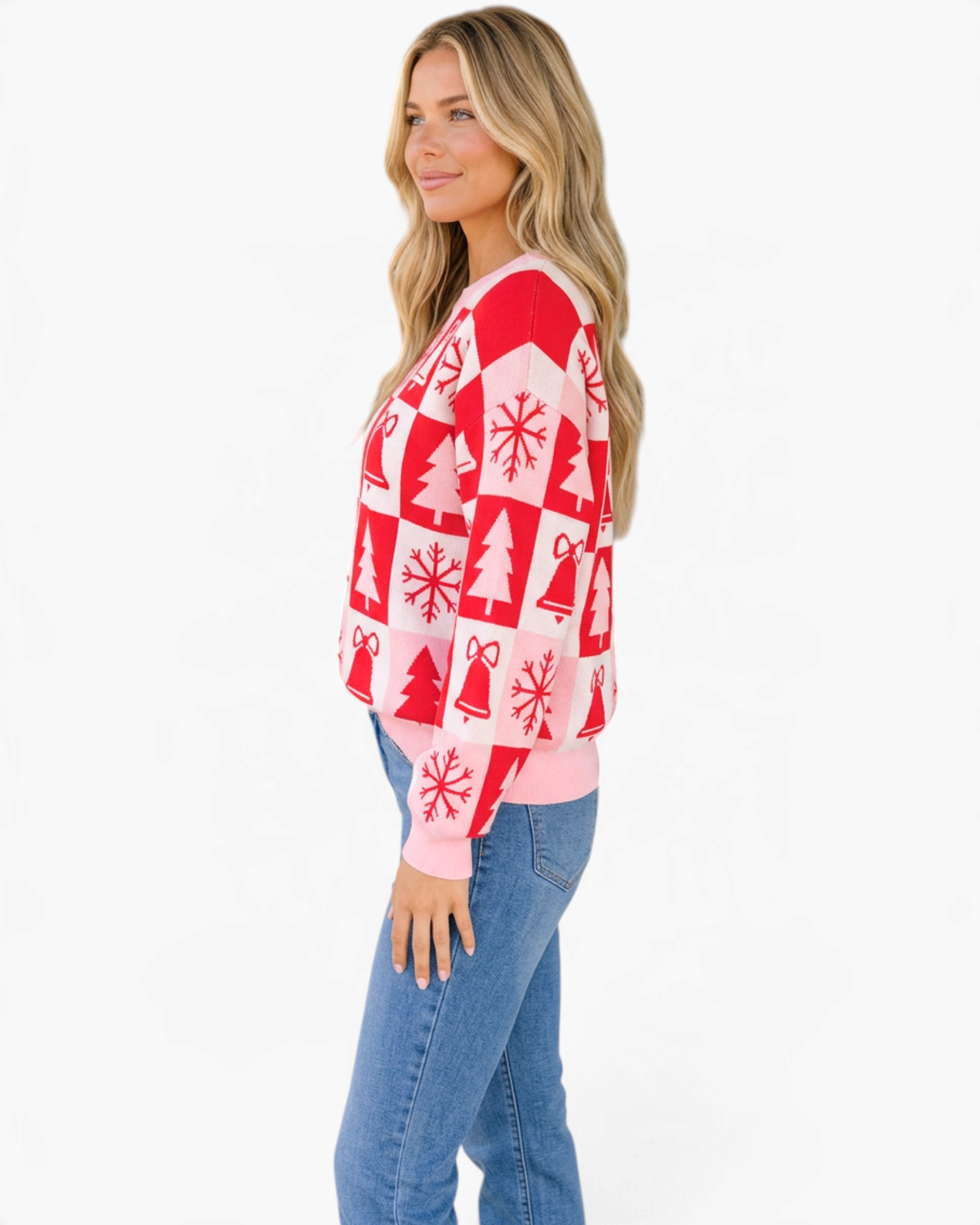 Model wearing a Beach Rose Co. pink and red Christmas checkerboard crewneck sweater with festive holiday motifs.