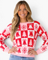 Beach Rose Co. pink and red Christmas checkerboard sweater with tree, bell, and snowflake motifs and ribbed trim.