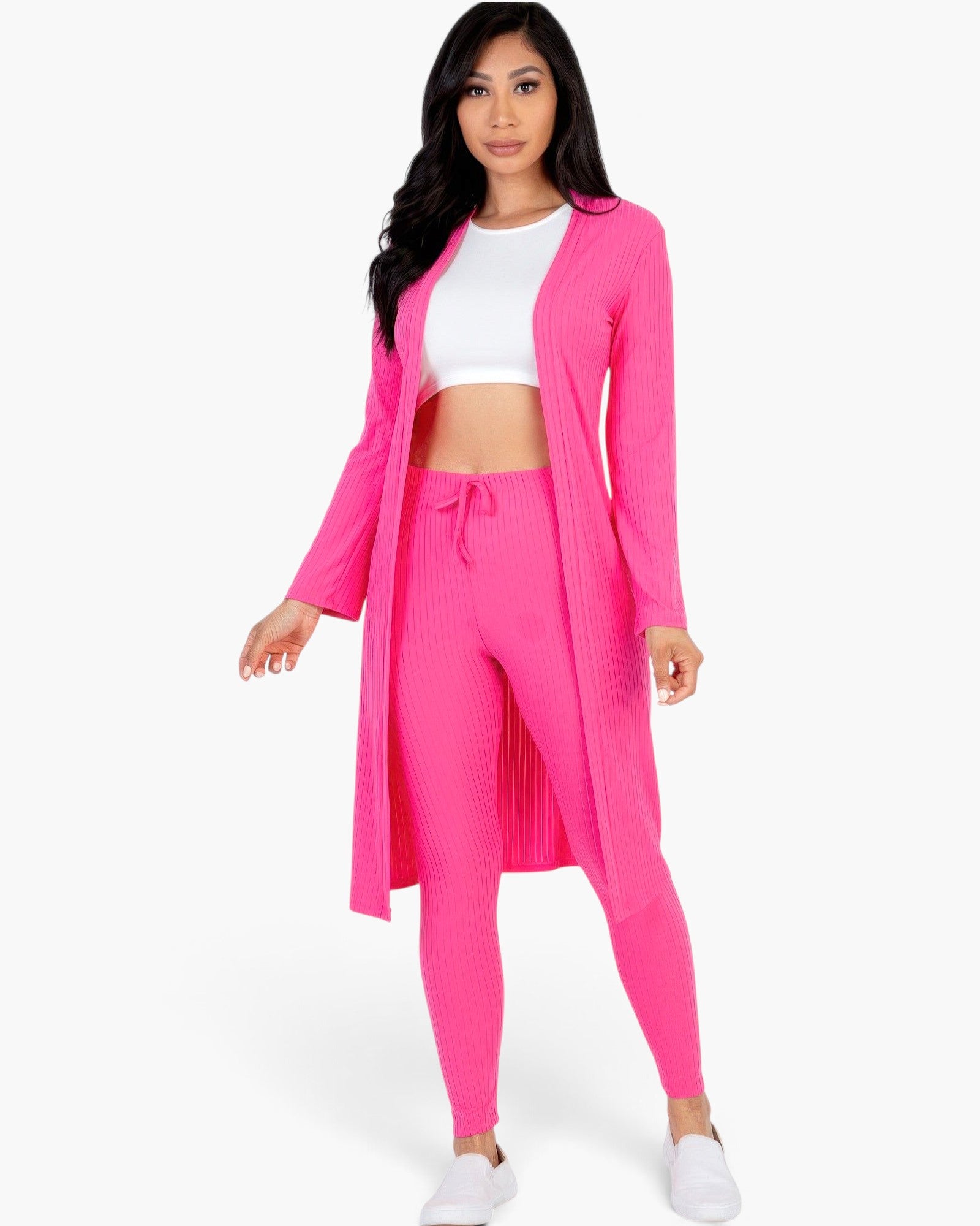 Beach Rose Co. bright pink ribbed long cardigan and leggings set worn by a model with a white crop top and sneakers.
