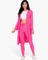 Beach Rose Co. bright pink ribbed long cardigan and leggings set worn by a model with a white crop top and sneakers.