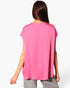 Beach Rose Co. pink washed poly silk tunic top with a relaxed fit and tulip hemline, back view on a model.