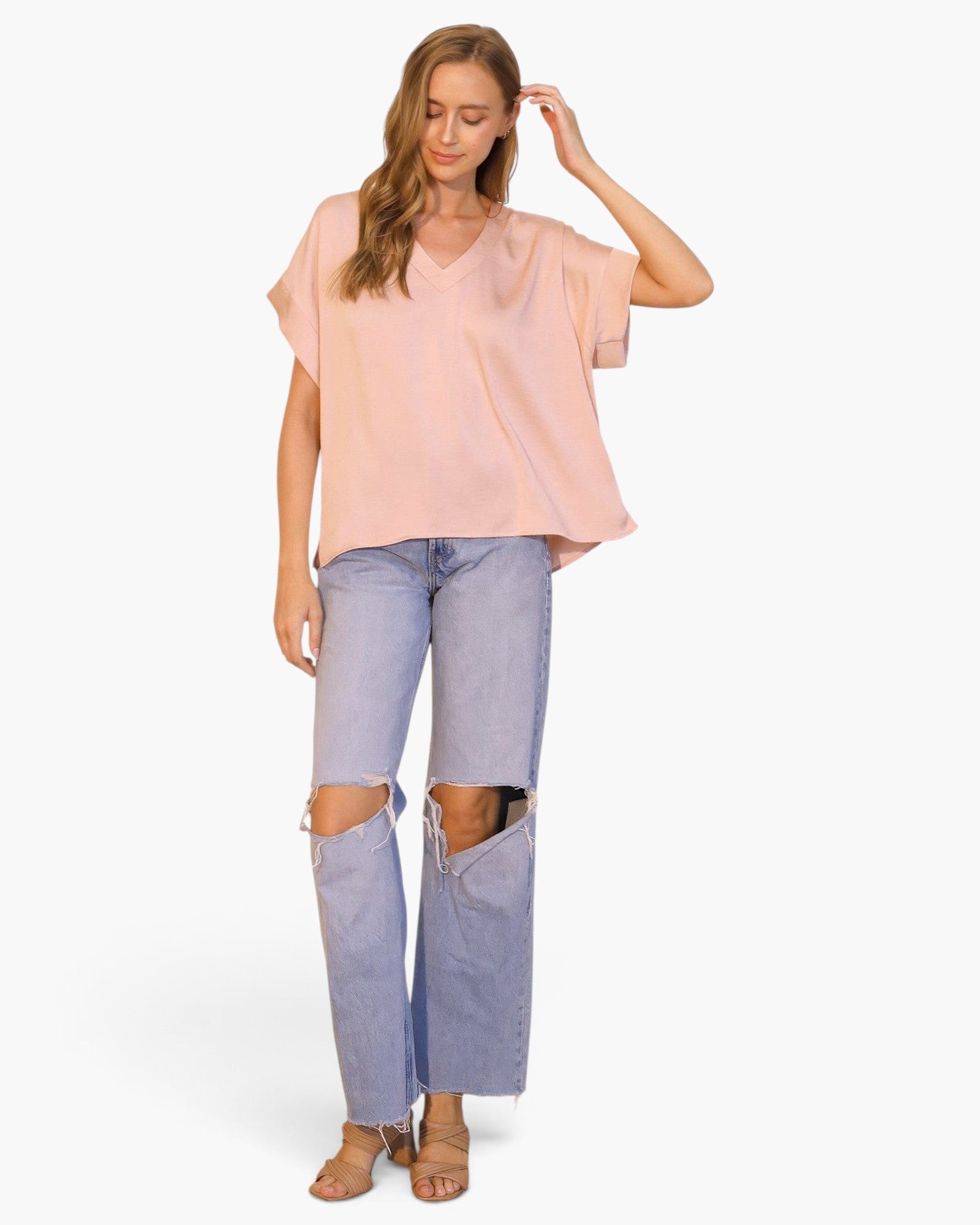 Beach Rose Co. model wearing a light pink washed poly silk V-neck tee with relaxed fit and cuffed short sleeves.
