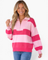 Beach Rose Co. model wearing a pink and fuchsia striped knit sweater with a half-zip collar and balloon sleeves.