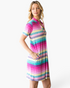 Beach Rose Co. pink multi-stripe shift dress with notched neckline, short sleeves, and side pockets on a model.