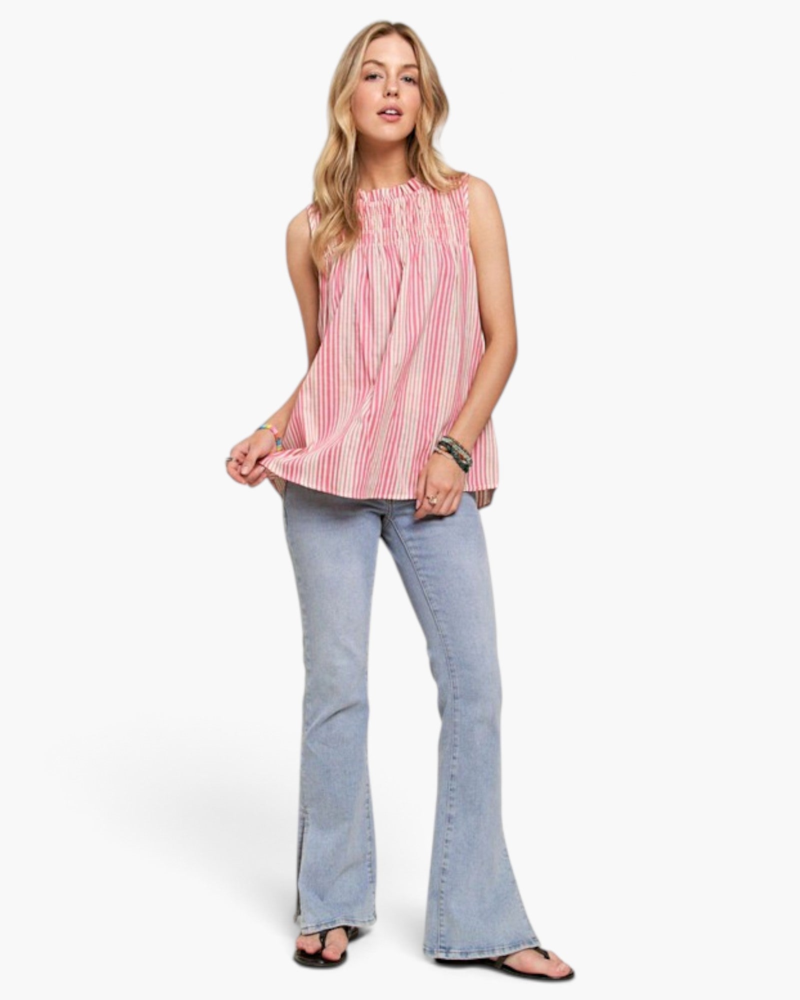 Beach Rose Co. model wearing a hot pink and ivory striped cotton-linen sleeveless top with a ruffled neckline.