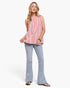 Beach Rose Co. model wearing a hot pink and ivory striped cotton-linen sleeveless top with a ruffled neckline.