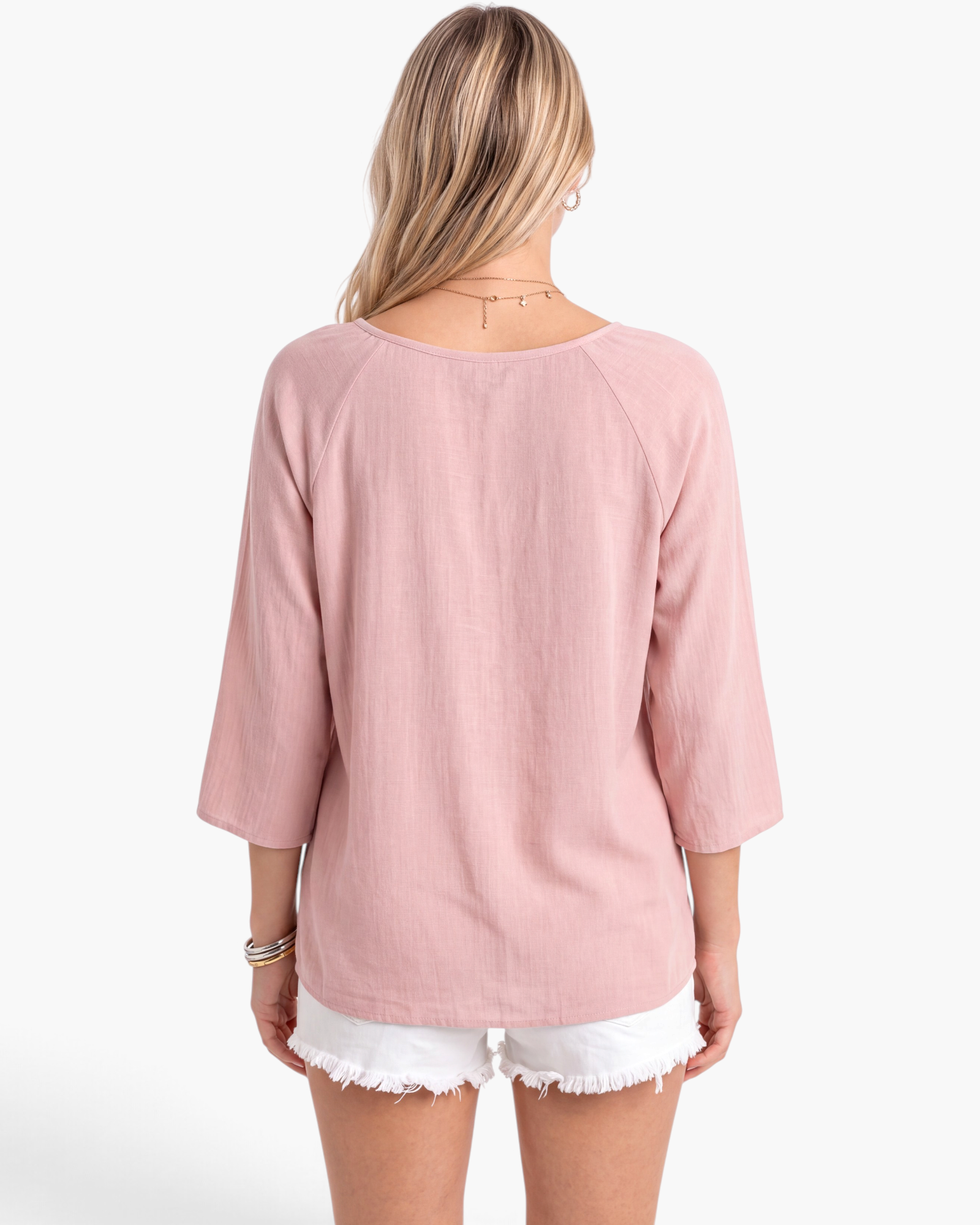 Back view of a Beach Rose Co. pink textured polyester blouse with three-quarter sleeves and a relaxed fit.