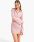 Beach Rose Co. model wearing a light pink waffle knit two-piece set with a collared bell sleeve top and mini skirt