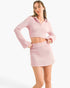 Beach Rose Co. pink waffle knit two-piece set featuring a cropped polo top with bell sleeves and a matching mini skirt.