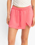 Beach Rose Co. pink wrap front skort with an elastic drawstring waistband and built-in shorts in stretch fabric.