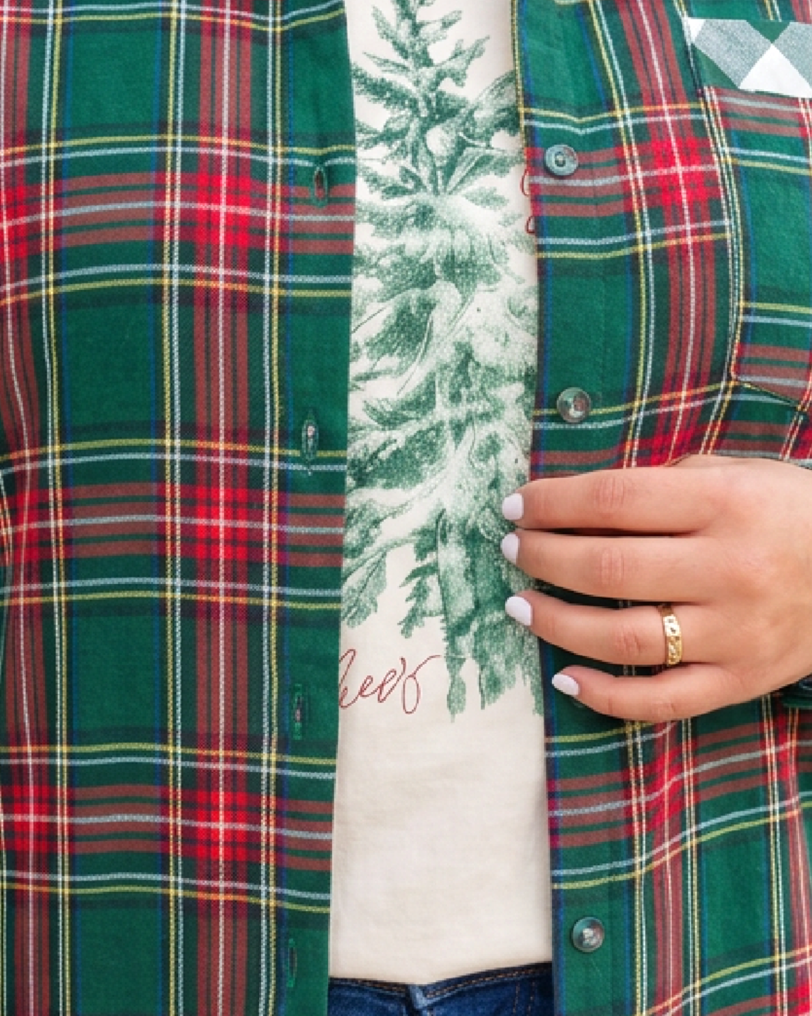 Beach Rose Co. green and red plaid shirt with gingham pocket detail worn over a graphic tee