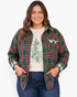 Beach Rose Co. plus size green and red plaid shirt with gingham trim worn open over a graphic tee and jeans.