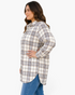 Beach Rose Co. plus-size cream and taupe plaid longline shacket with a curved hem worn by a woman