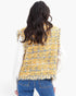 Back view of a Beach Rose Co. yellow and blue plaid tweed vest with frayed raw edges worn over a white sweater.