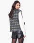 Beach Rose Co. plaid tweed vest with frayed edges worn over a white sweater and black skirt, back view.