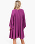 Back view of a Beach Rose Co. plum babydoll dress with tiered bell sleeves and gathered detailing on a blonde model.