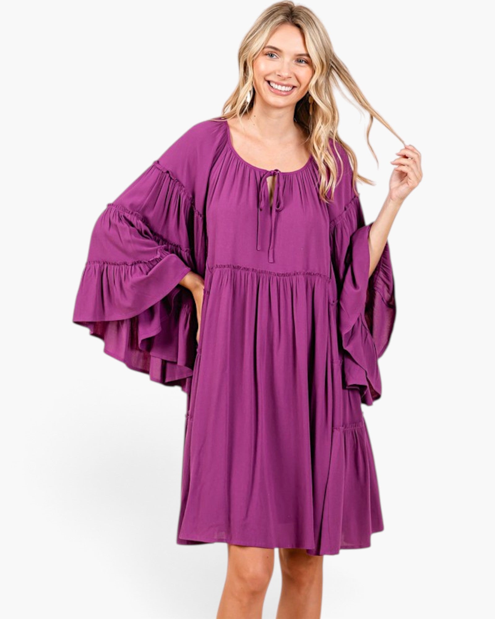 Beach Rose Co. plum babydoll dress with tiered bell sleeves, gathered neckline, and relaxed fit on a smiling model.