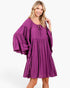 Beach Rose Co. plum babydoll dress with tiered bell sleeves, gathered neckline, and relaxed fit on a smiling model.