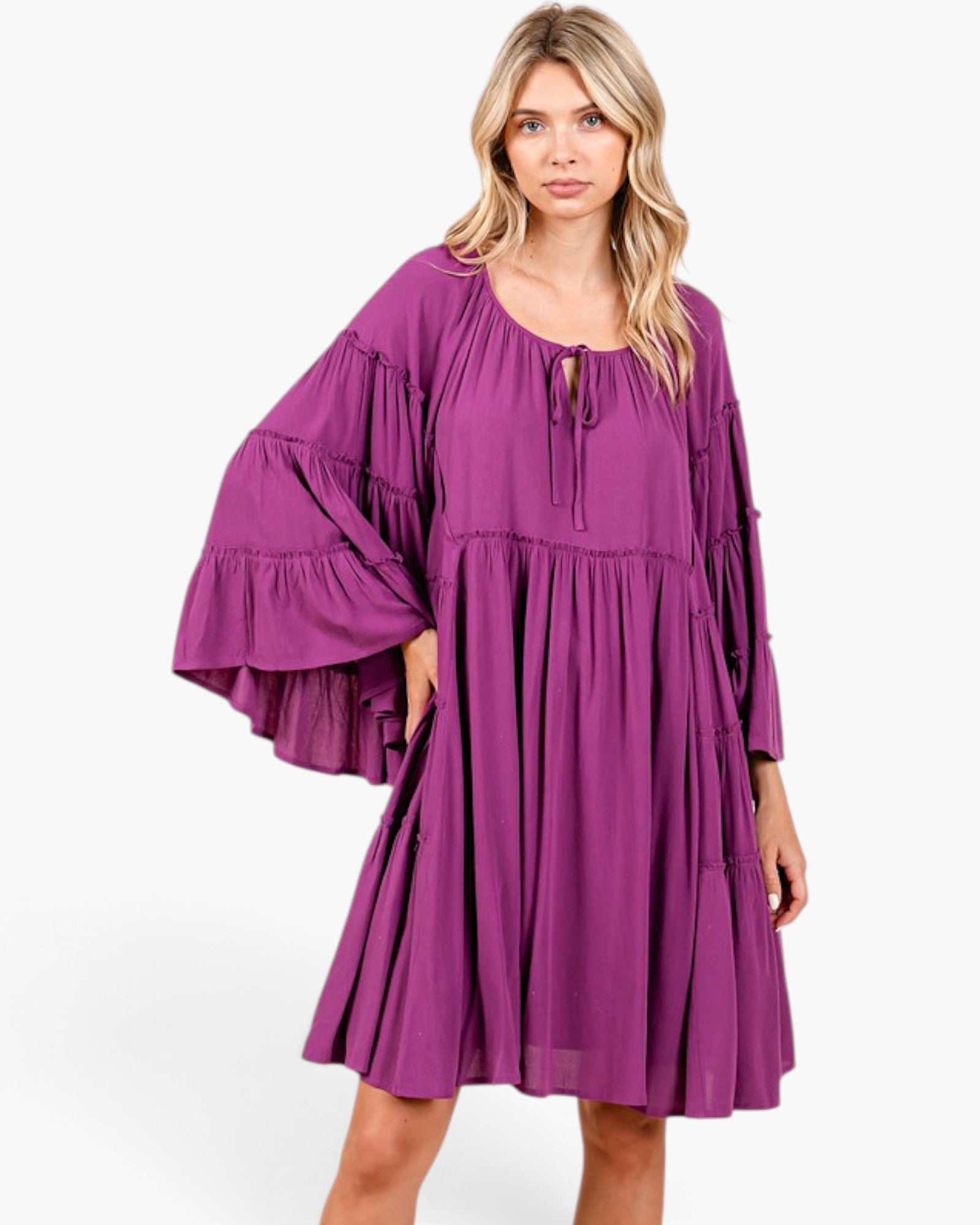 Beach Rose Co. plum babydoll dress with tiered bell sleeves, gathered neckline, and relaxed fit on a blonde model.