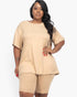 Beach Rose Co. plus size beige loose fit top and matching biker shorts set on a model with long dark wavy hair.