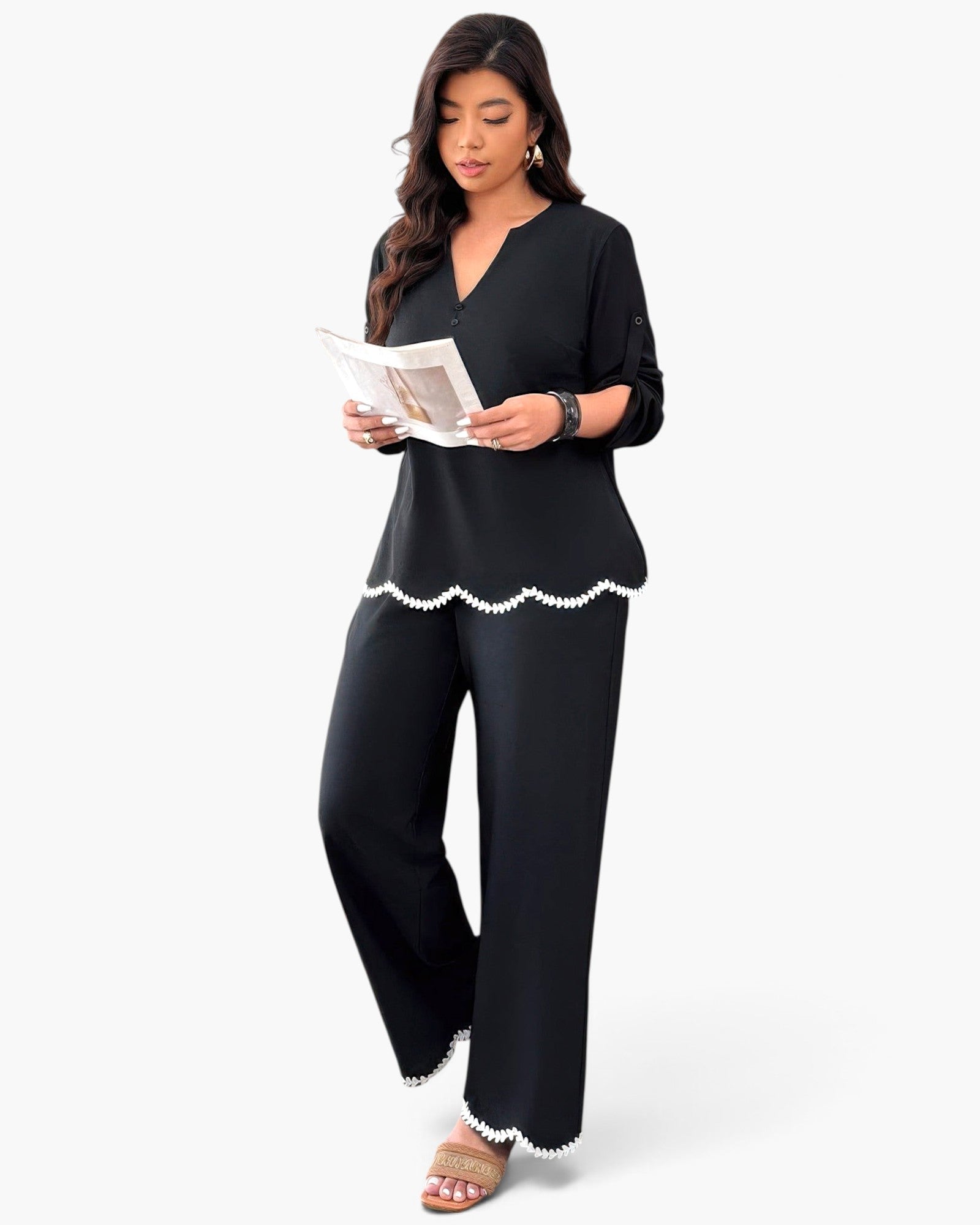 Beach Rose Co. plus size black two-piece set with white ruffle trim on the hem and sleeves, worn by a model.