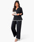 Beach Rose Co. plus size black two-piece set with white ruffle trim on the hem and sleeves, worn by a model.