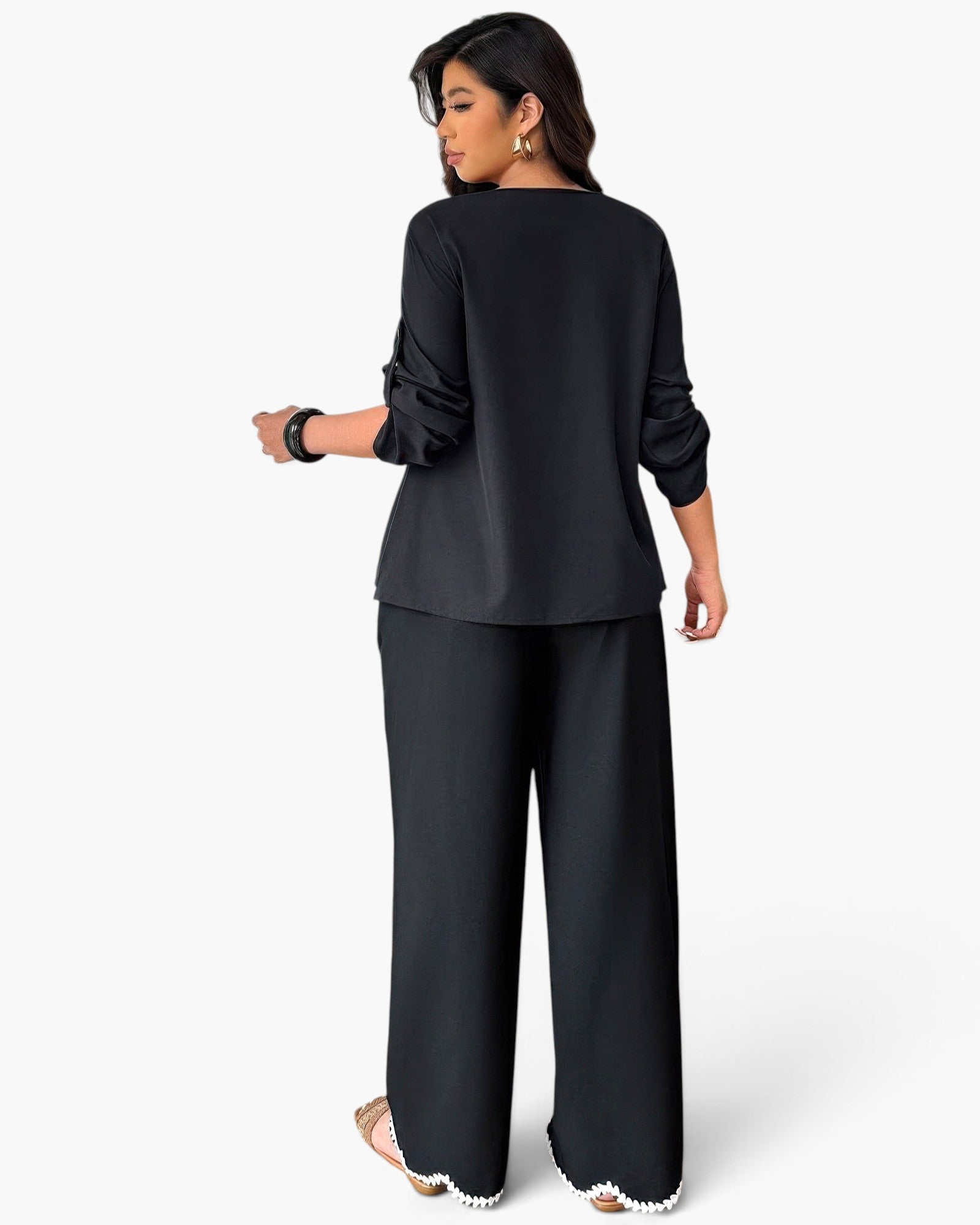 Beach Rose Co. plus size black two-piece set with ruffle trim and contrast white hem detail worn by a model