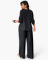 Beach Rose Co. plus size black two-piece set with ruffle trim and contrast white hem detail worn by a model