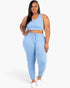 Beach Rose Co. plus size light blue French terry cropped tank top and joggers set worn by a smiling model.