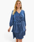 Beach Rose Co. plus size blue satin v-neck dress with long sleeves and a ruffled hem worn by a blonde model