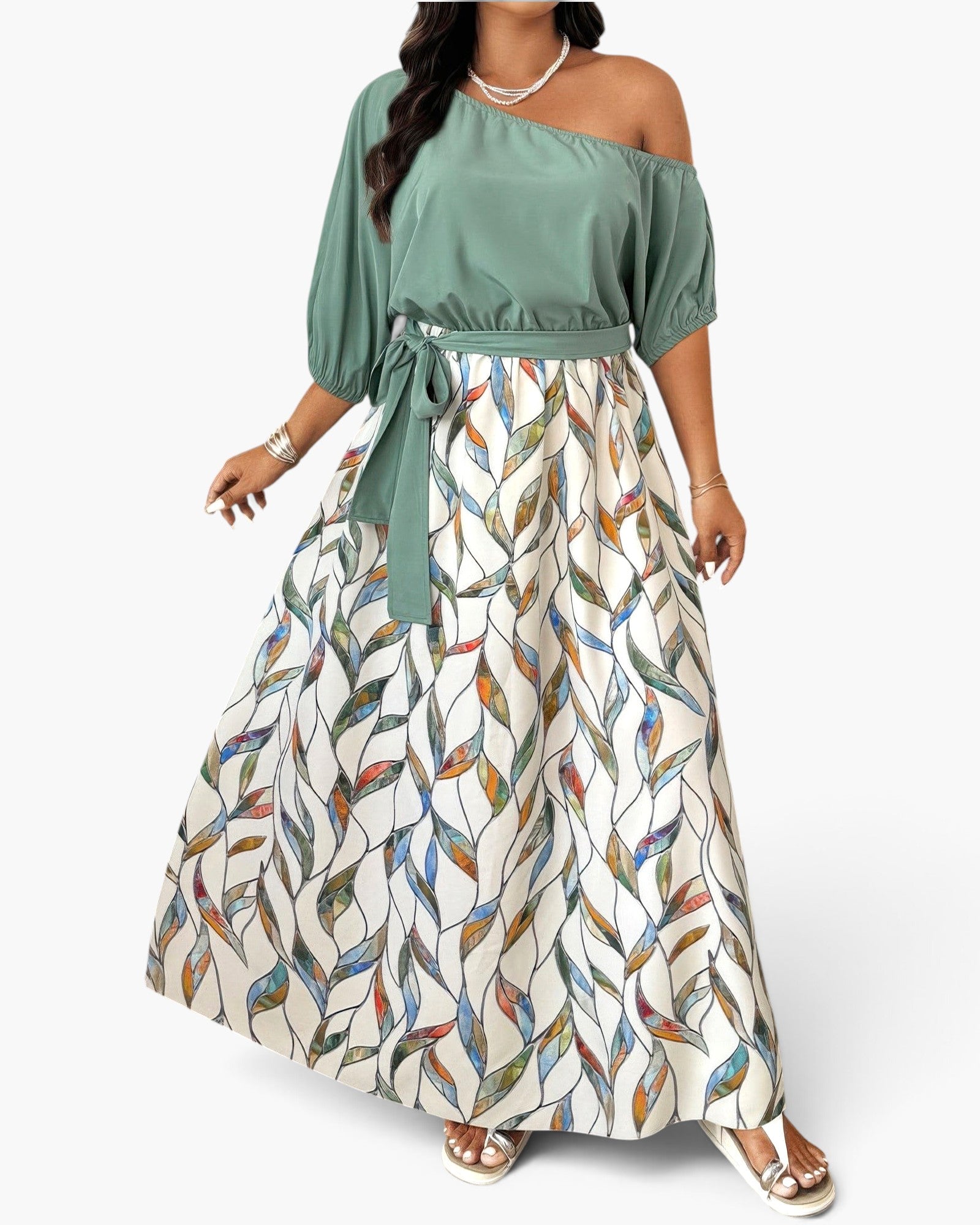 Beach Rose Co. plus size one-shoulder dress with a solid sage green top and a white skirt featuring a colorful leaf print.