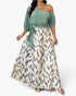 Beach Rose Co. plus size one-shoulder dress with a solid sage green top and a white skirt featuring a colorful leaf print.