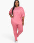 Beach Rose Co. plus size oversized pink t-shirt and leggings lounge set on a model with long dark hair.