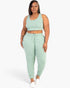 Beach Rose Co. plus size sage green French terry cropped tank top and drawstring jogger lounge set on a model