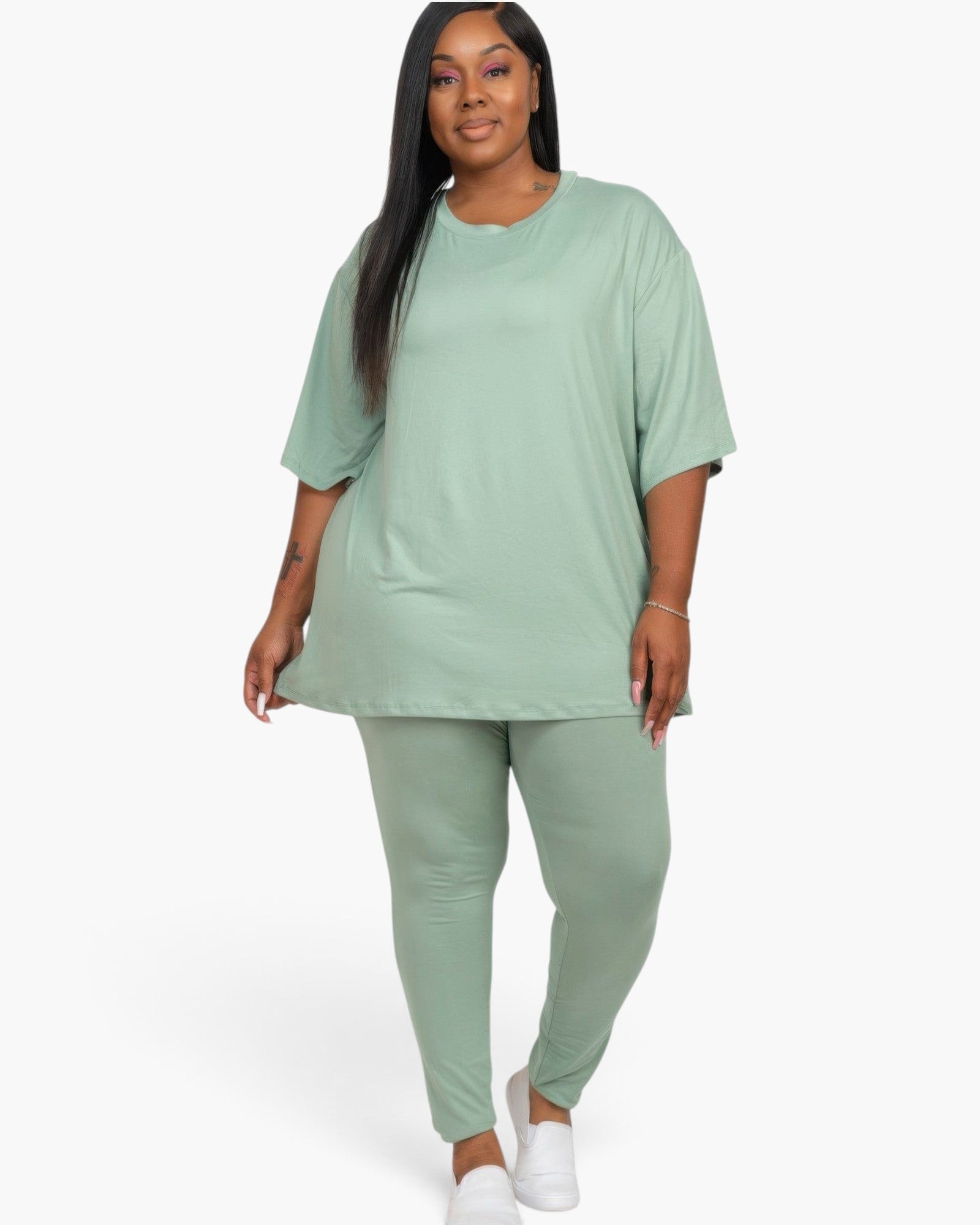 Beach Rose Co. plus size model wearing a sage green oversized t-shirt and matching leggings set with white sneakers.