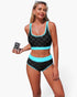 Beach Rose Co. black and blue polka-dot high-waisted bikini set with contrast trim and scoop-neck top on a model