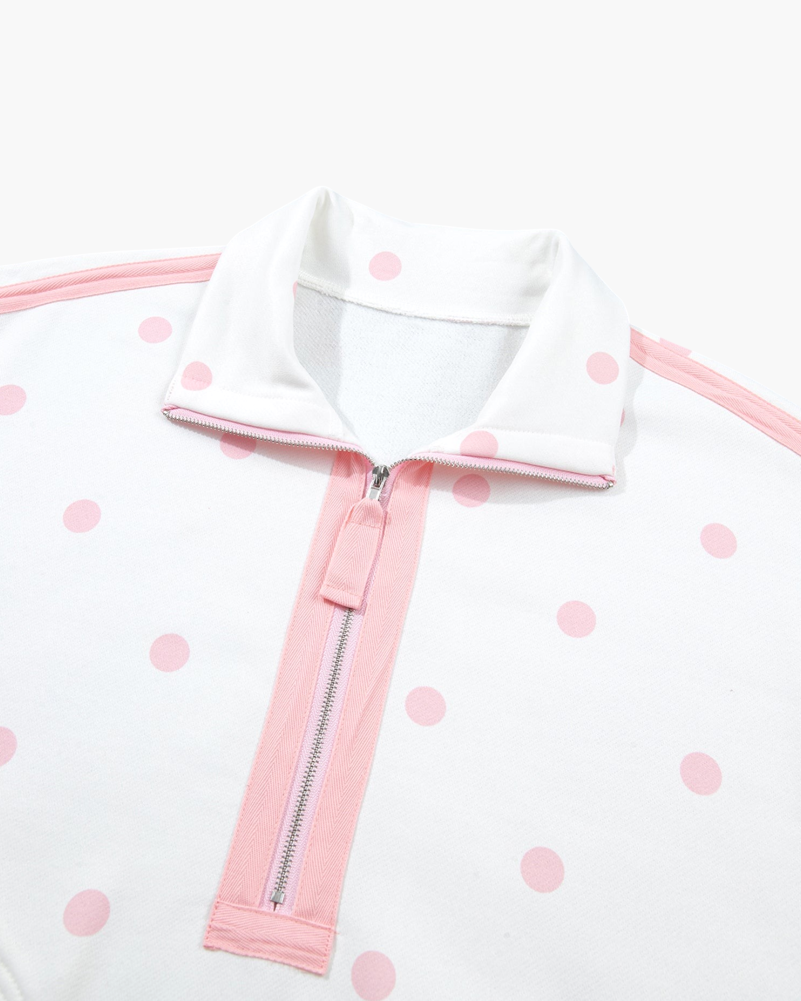 Beach Rose Co. white polyester sweatshirt featuring a pink polka dot pattern, half-zip neckline, and pink trim.