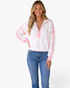 Beach Rose Co. white half-zip sweatshirt with pink polka dots, contrast trim, and dropped shoulders on a model.