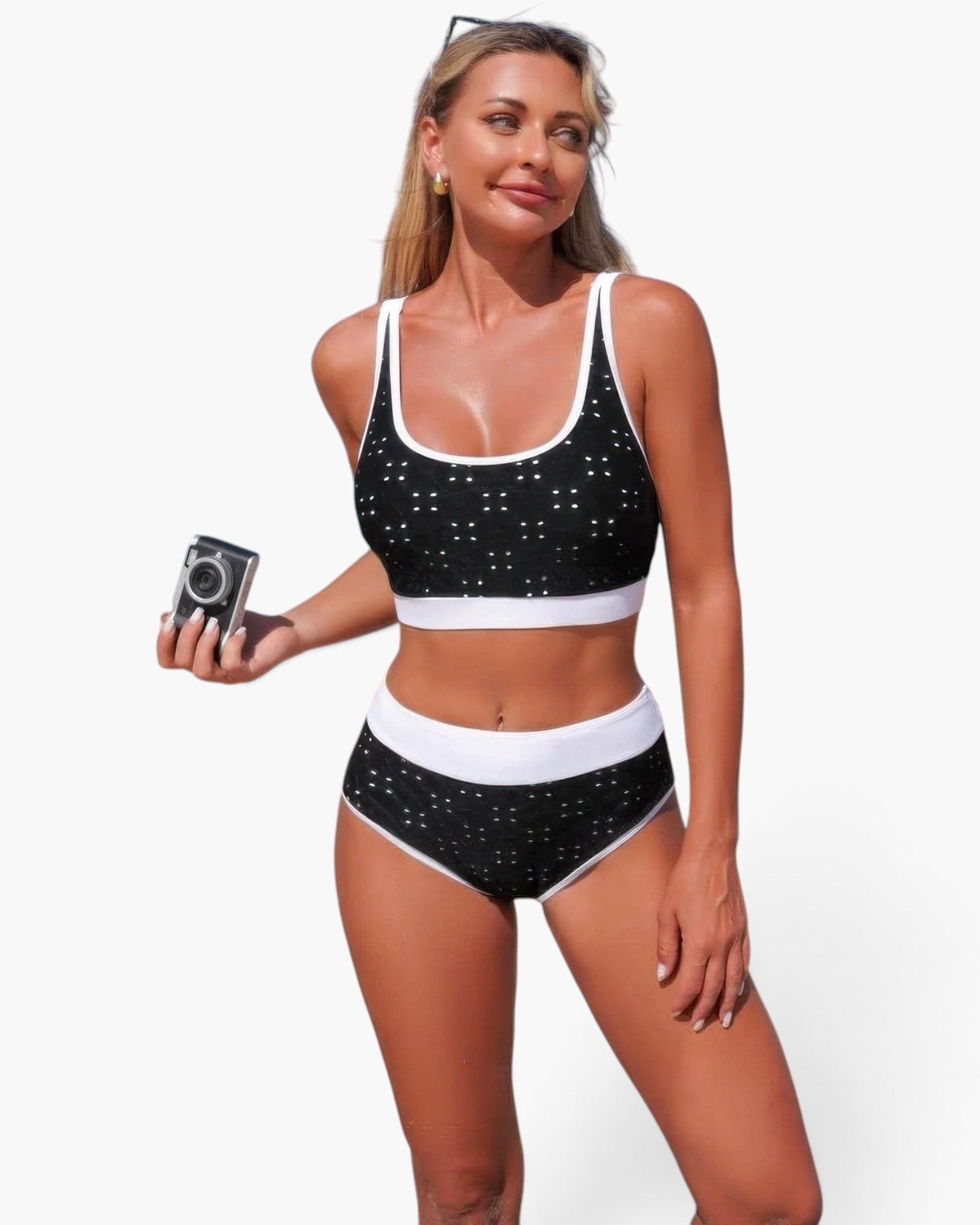 Beach Rose Co. black and white polka-dot high-waisted bikini set with contrast trim worn by a model on the beach.