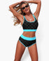Beach Rose Co. black polka-dot high-waisted bikini set with bright blue contrast trim and scoop-neck top on a model.