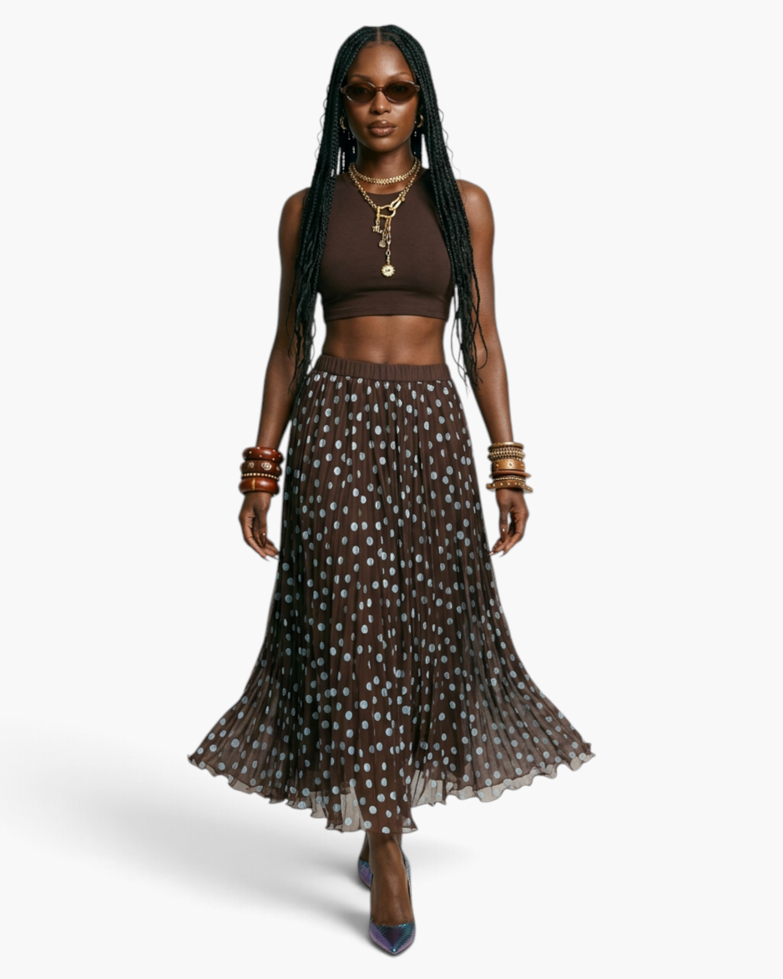Beach Rose Co. brown polka dot pleated maxi skirt with an elastic waistband worn by a model with a brown crop top.