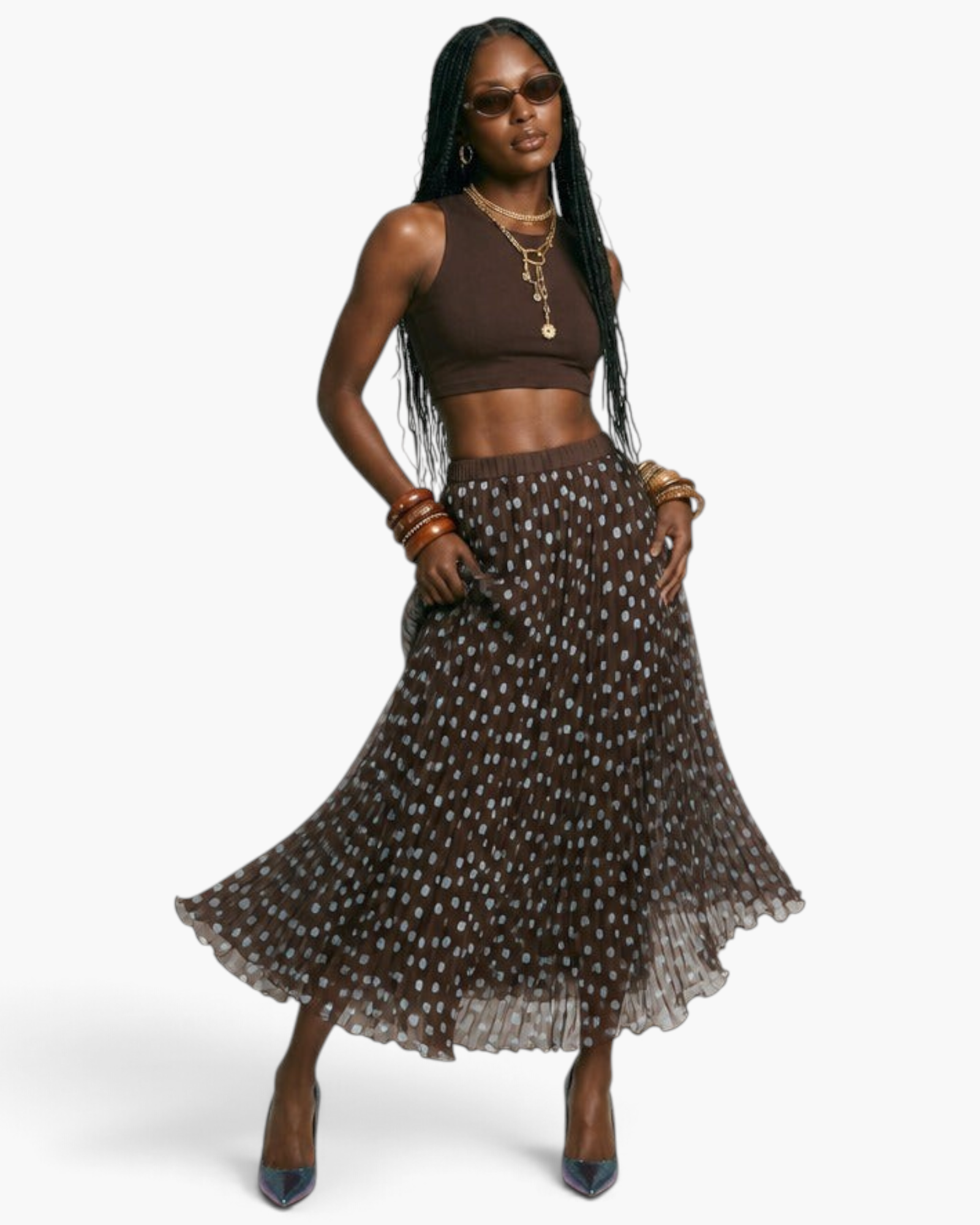 Beach Rose Co. model wearing a brown polka dot pleated maxi skirt with an elastic waistband and a brown crop top.