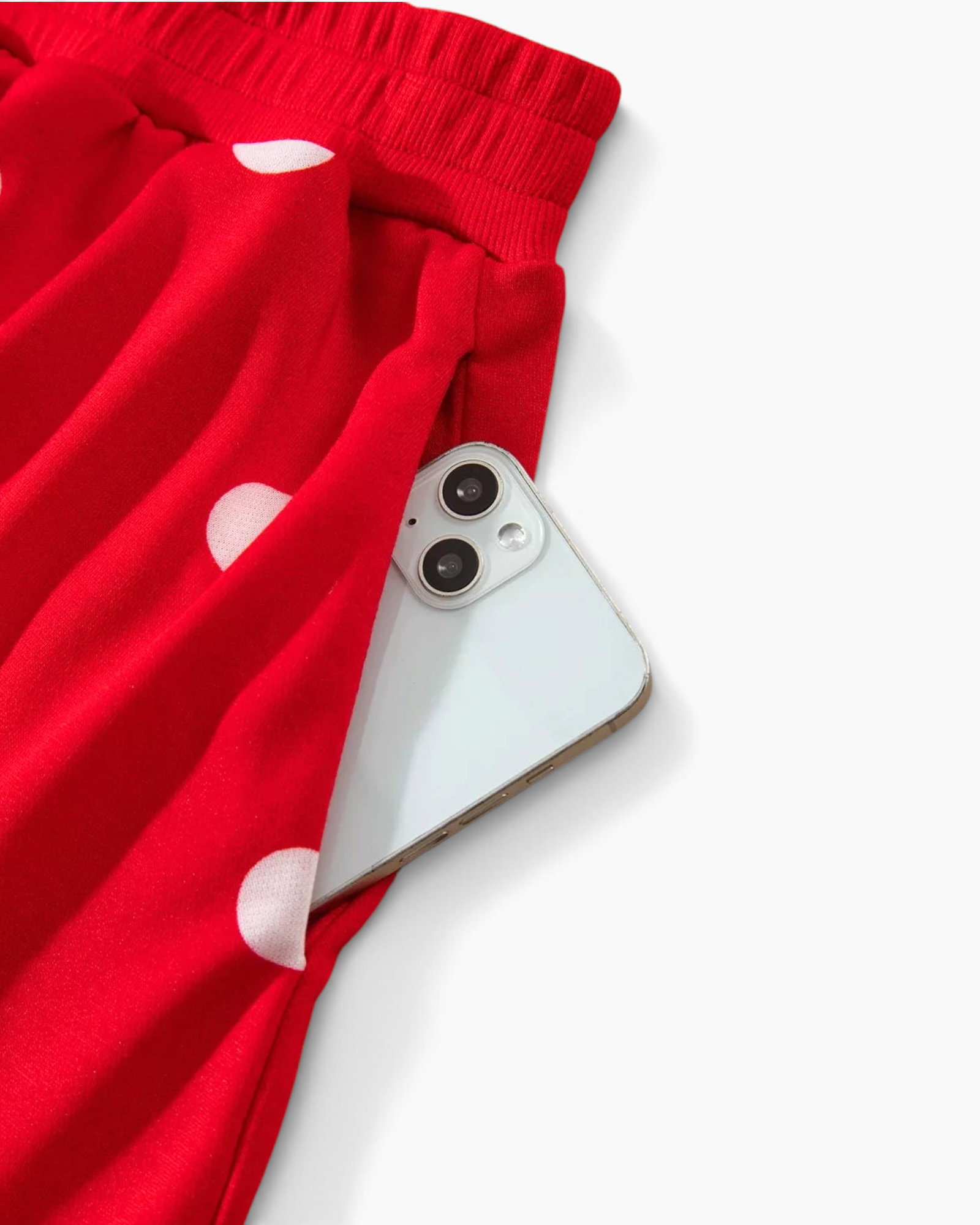 Beach Rose Co. red and white polka dot polyester skort featuring a functional side pocket holding a smartphone.
