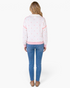 Beach Rose Co. white sweatshirt with pink polka dots, half-zip collar, and pink trim, worn by a blonde model.