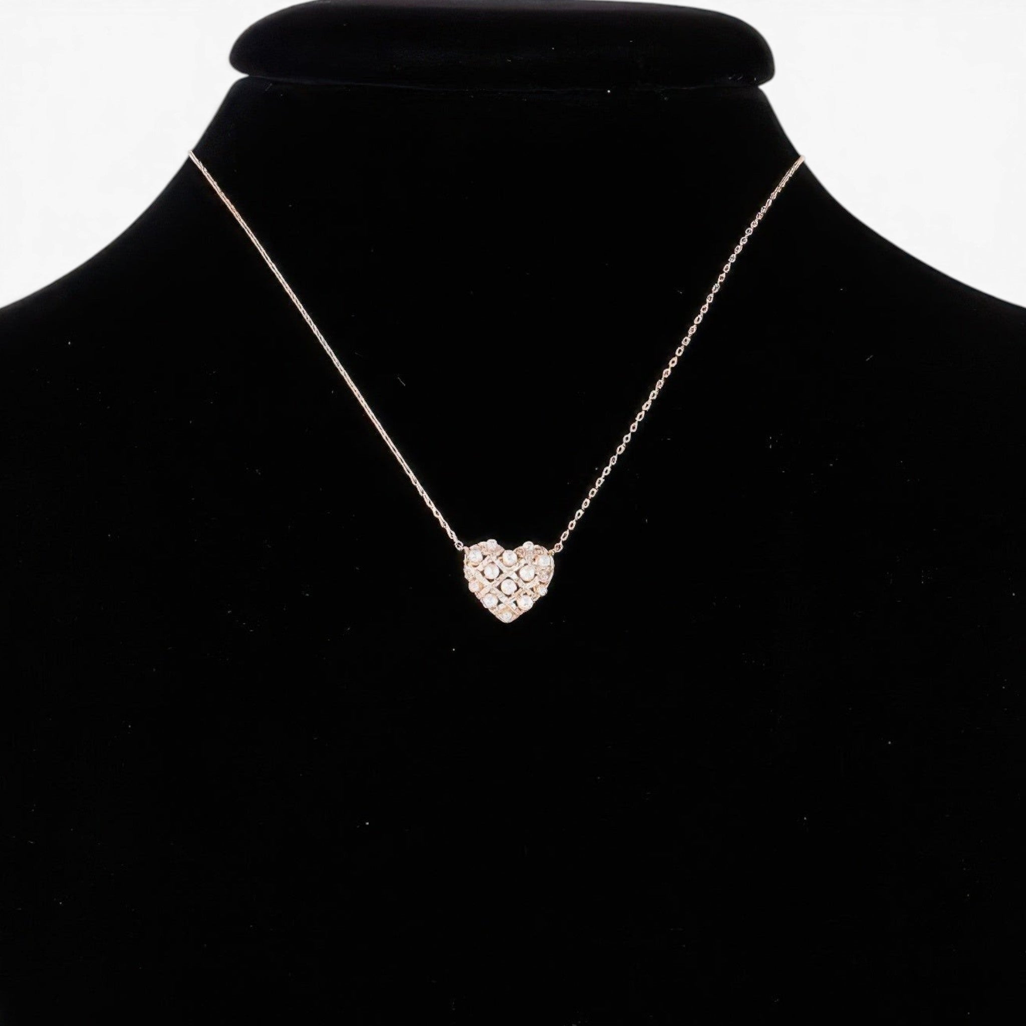 Beach Rose Co. gold quilted heart necklace featuring lustrous pearls on a delicate chain displayed on a black bust