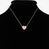 Beach Rose Co. gold quilted heart necklace featuring lustrous pearls on a delicate chain displayed on a black bust