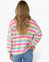 Beach Rose Co. pink and pastel rainbow striped knit cardigan with long sleeves and a relaxed fit, back view.