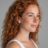 Beach Rose Co. rectangular moissanite halo stud earrings worn by a woman with long red curly hair