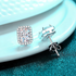 Beach Rose Co. rectangular moissanite stud earrings with zircon halos in rhodium-plated sterling silver.