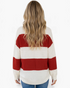 Back view of a model wearing a Beach Rose Co. red and cream wide stripe acrylic sweater with dropped shoulders.
